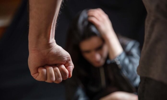 Woman abuse, Young woman scared, male clenched fist close up. Do