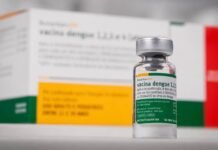Ministério da Saúde suspende vacina da dengue do Butantan após dois óbitos suspeitos Frasco da vacina da dengue do Butantan em destaque, com embalagem ao fundo, após suspensão temporária pelo Ministério da Saúde.